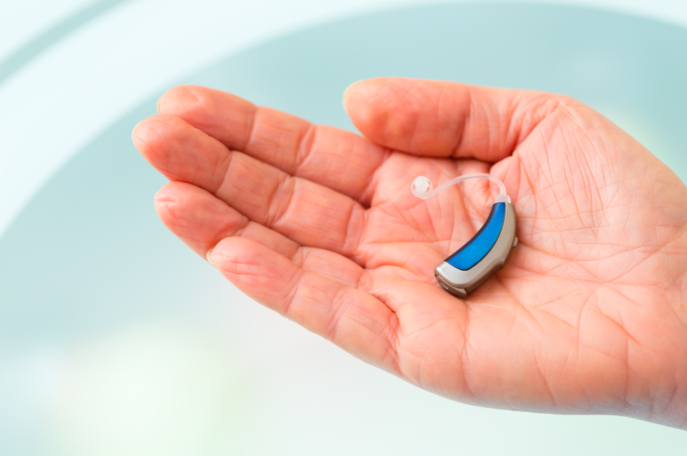 a hearing aid in a hand