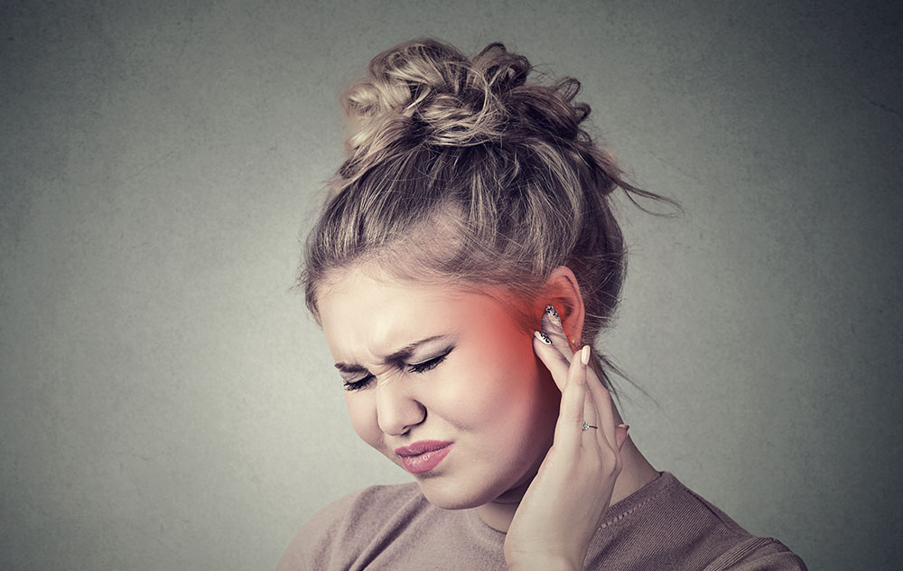 a woman experiencing slight ear discomfort