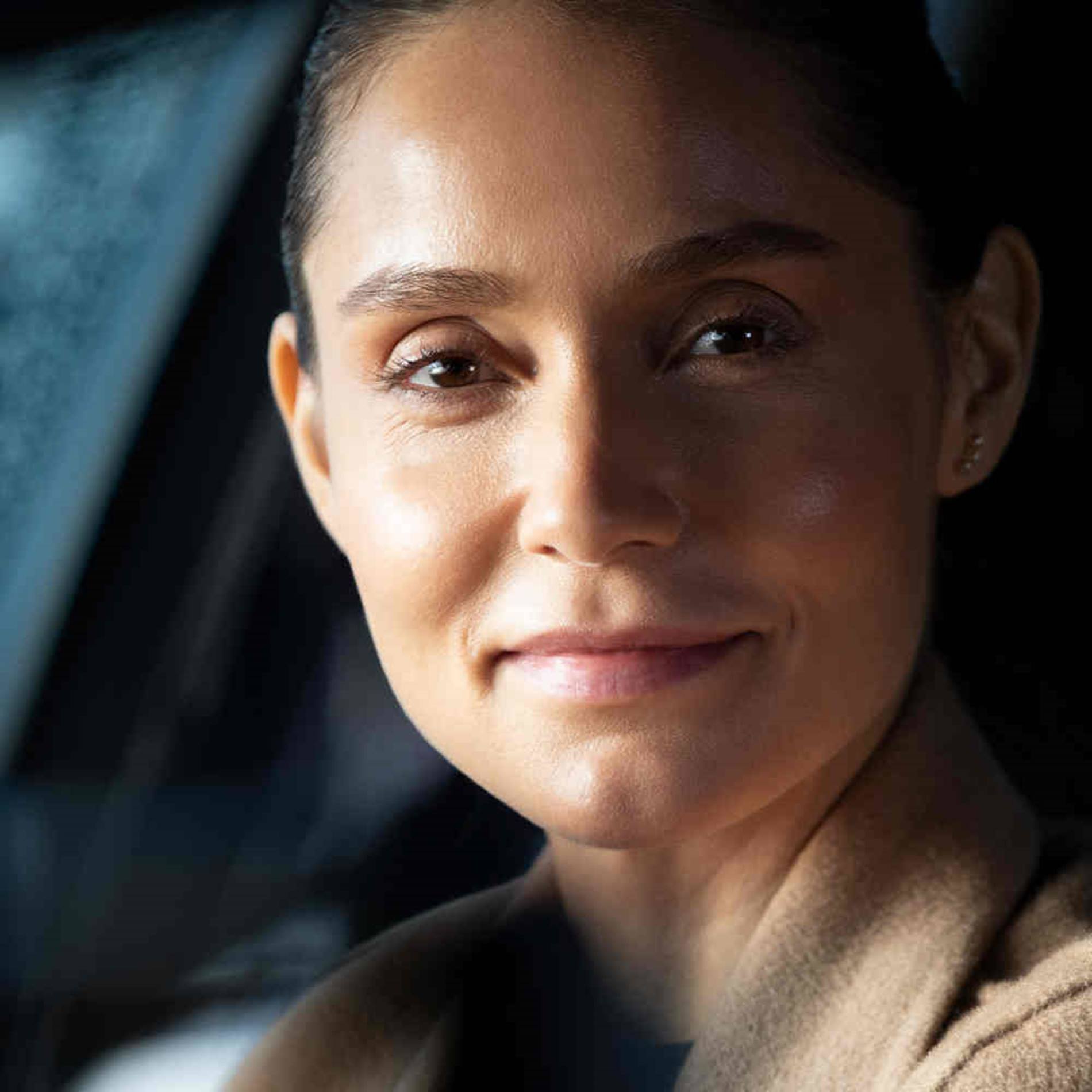 woman-sitting-in-car-smiling-at-camera